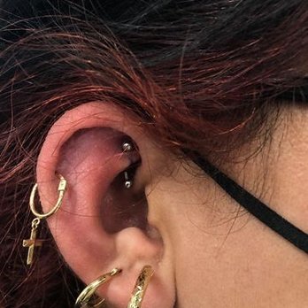 Ear with hoop and cartilage piercings