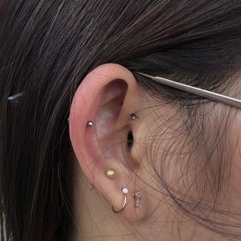 Curated ear with multiple visible piercings