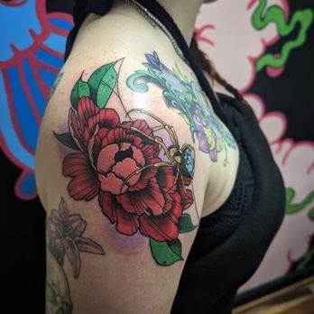 Colorful floral tattoo on a shoulder