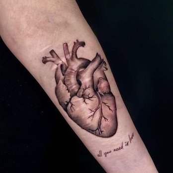 Anatomical heart tattoo on a forearm
